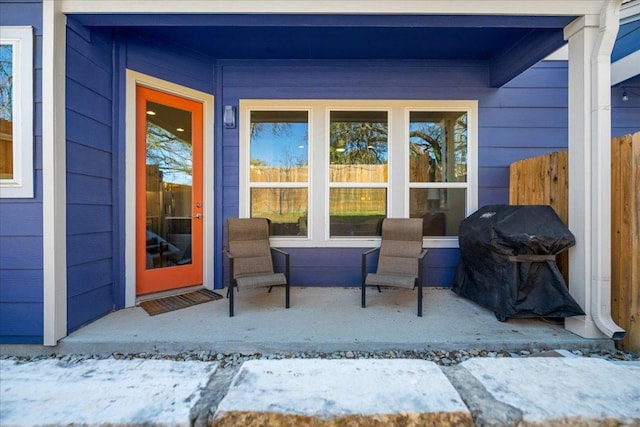 view of patio with a grill and fence