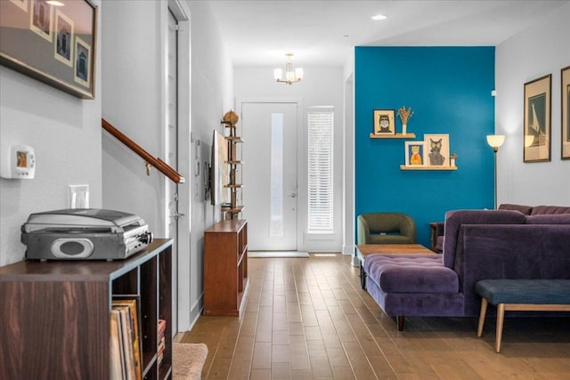 foyer entrance featuring recessed lighting, wood finished floors, and a notable chandelier