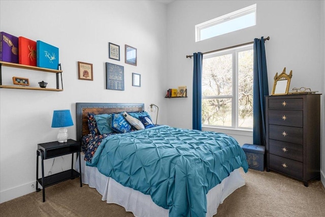 carpeted bedroom featuring baseboards