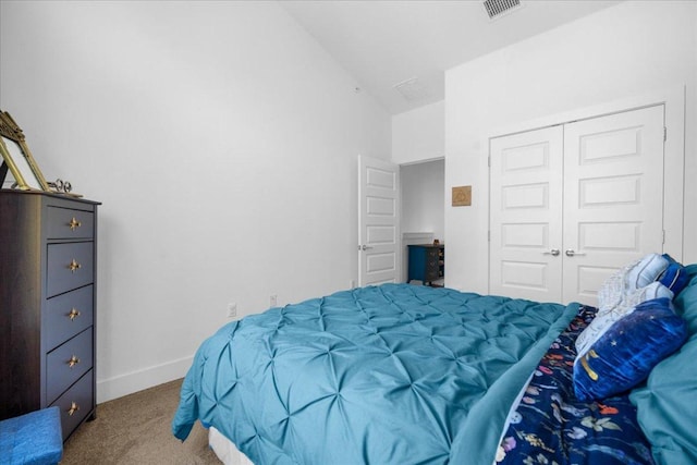 bedroom featuring carpet, a closet, visible vents, vaulted ceiling, and baseboards