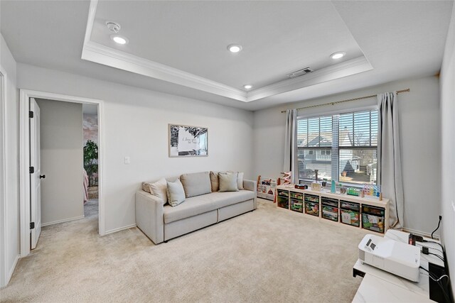 living area featuring ornamental molding, a tray ceiling, carpet, and recessed lighting