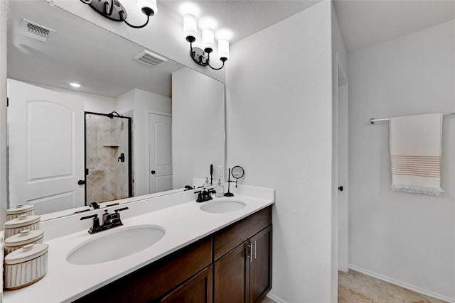 bathroom featuring a stall shower, visible vents, and a sink