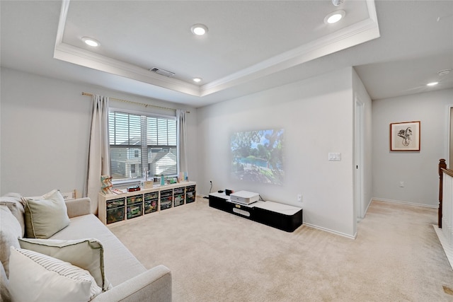 sitting room with recessed lighting, a raised ceiling, light colored carpet, and crown molding