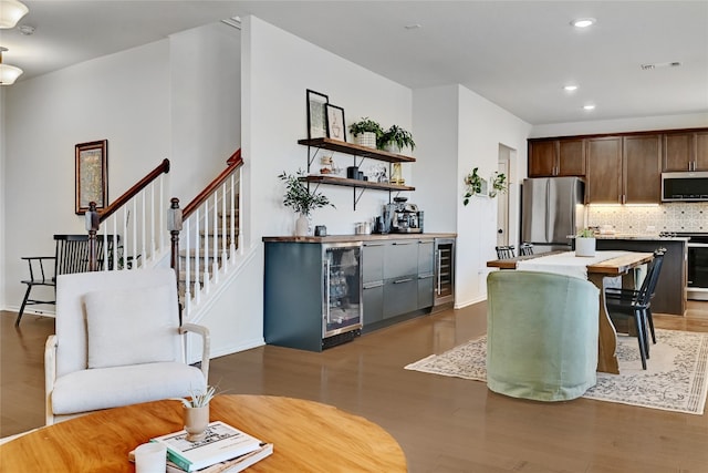 kitchen featuring wine cooler, light countertops, visible vents, appliances with stainless steel finishes, and wood finished floors