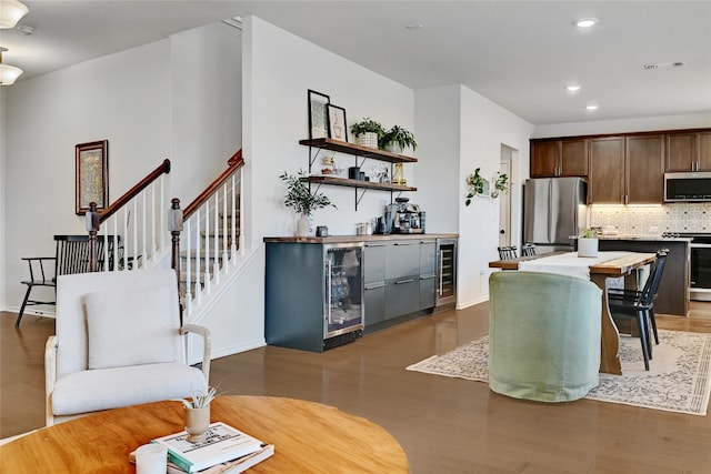 6808 Ellsworth Walk, Austin, TX 78724 - living room with beverage cooler, recessed lighting, wood finished floors, and a bar