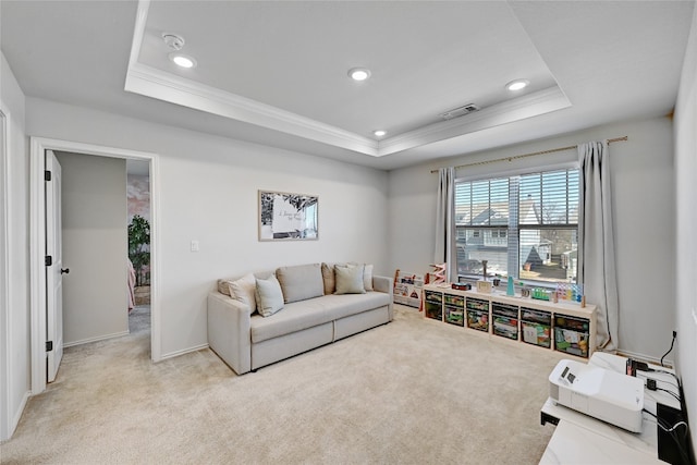 carpeted living room with ornamental molding, a tray ceiling, visible vents, and recessed lighting