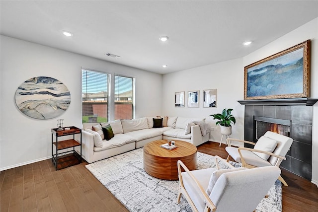 6808 Ellsworth Walk, Austin, TX 78724 - living area with wood finished floors, a tile fireplace, and recessed lighting