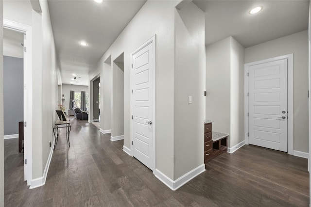 hallway with dark wood-style floors, recessed lighting, and baseboards