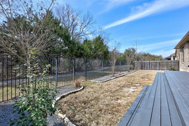 view of yard featuring a fenced backyard and a deck