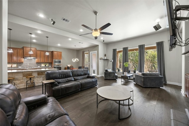 living room with baseboards, visible vents, dark wood finished floors, ceiling fan, and recessed lighting