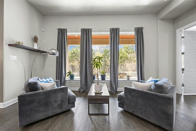 living area with dark wood-style floors and baseboards