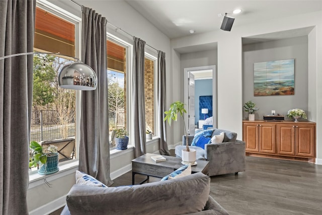 living area featuring baseboards and wood finished floors