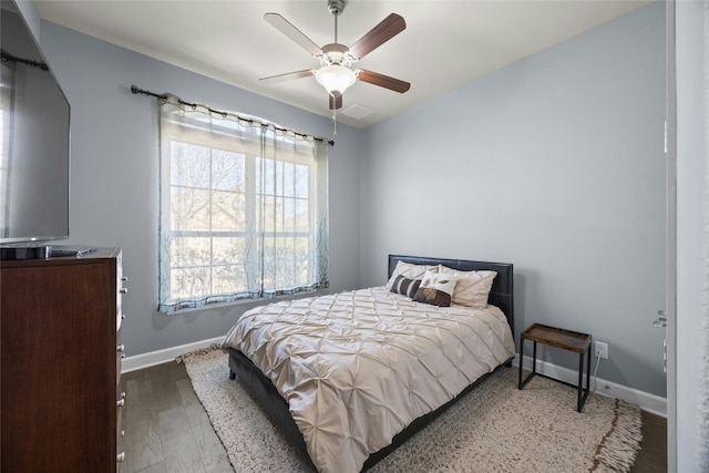 bedroom featuring ceiling fan, wood finished floors, and baseboards