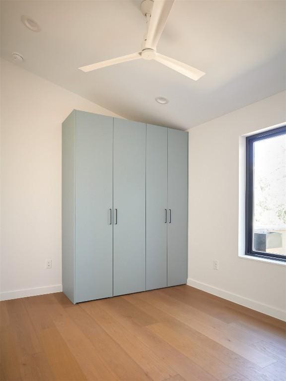 2703 Pegram Ave, Austin, TX 78757 - unfurnished bedroom with light wood-type flooring, baseboards, ceiling fan, and a closet