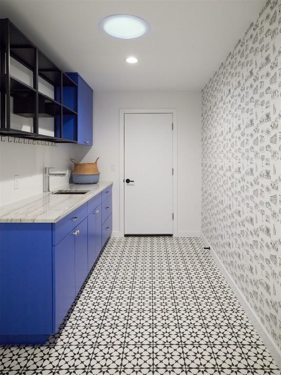 2703 Pegram Ave, Austin, TX 78757 - washroom with wallpapered walls, baseboards, a sink, and recessed lighting