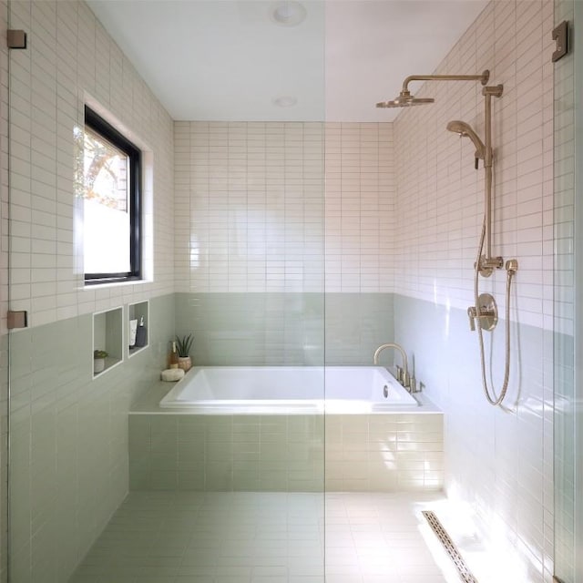 2703 Pegram Ave, Austin, TX 78757 - bathroom with tile walls, tiled shower, and a garden tub