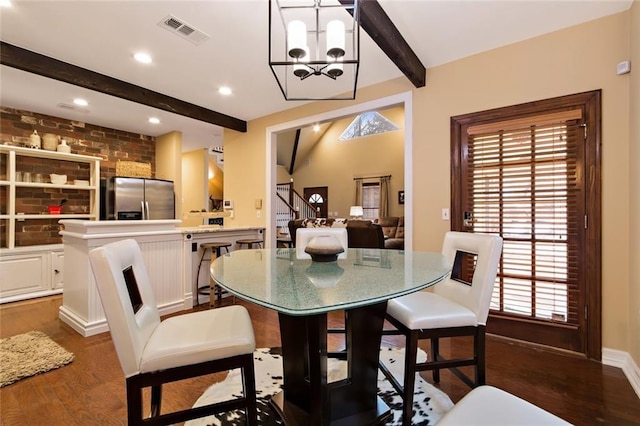 dining space with vaulted ceiling with beams, dark wood finished floors, visible vents, an inviting chandelier, and stairs