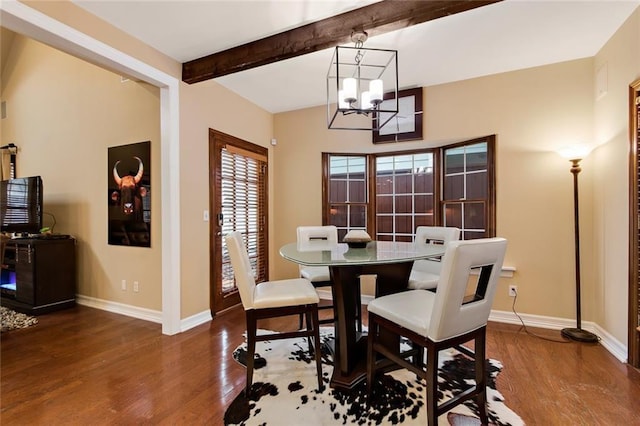 dining space featuring a notable chandelier, beamed ceiling, baseboards, and wood finished floors