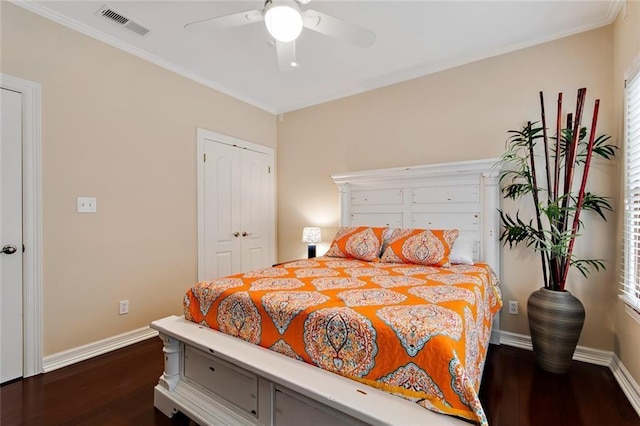 bedroom featuring a closet, wood finished floors, visible vents, and baseboards