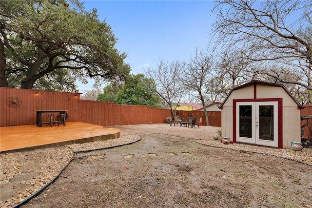 view of yard featuring an outbuilding, a fenced backyard, and a patio