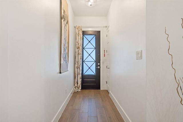 entryway featuring wood finished floors and baseboards