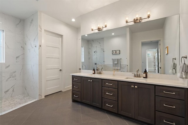 bathroom featuring recessed lighting, a sink, a marble finish shower, and double vanity