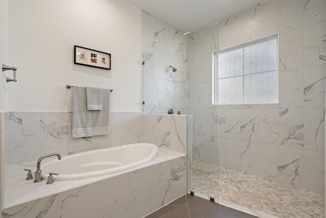 full bathroom with a walk in shower, a bath, and tile patterned floors