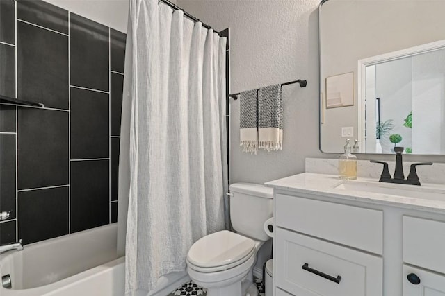 full bath featuring a textured wall, shower / bath combo, vanity, and toilet