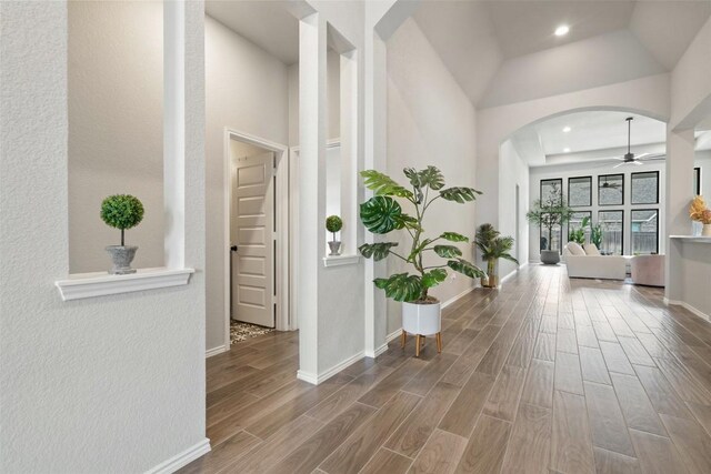 16801 Rakesh Way, Manor, TX 78653 - corridor featuring arched walkways, wood finished floors, baseboards, and recessed lighting