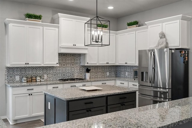 16801 Rakesh Way, Manor, TX 78653 - kitchen with stainless steel appliances, white cabinets, a chandelier, and recessed lighting