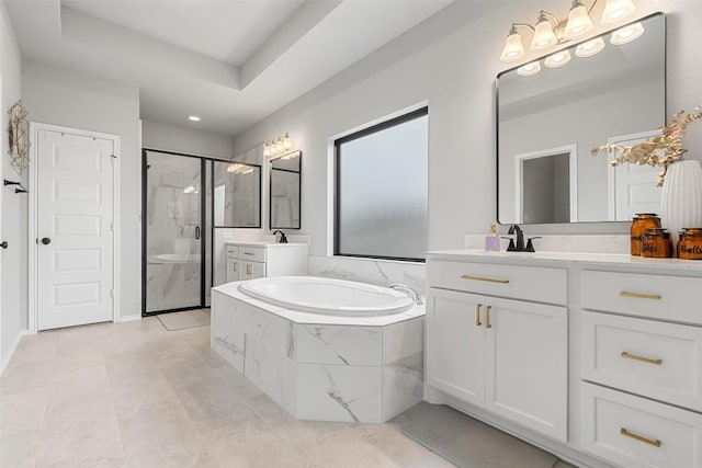 bathroom with a tray ceiling, a garden tub, a marble finish shower, two vanities, and a sink