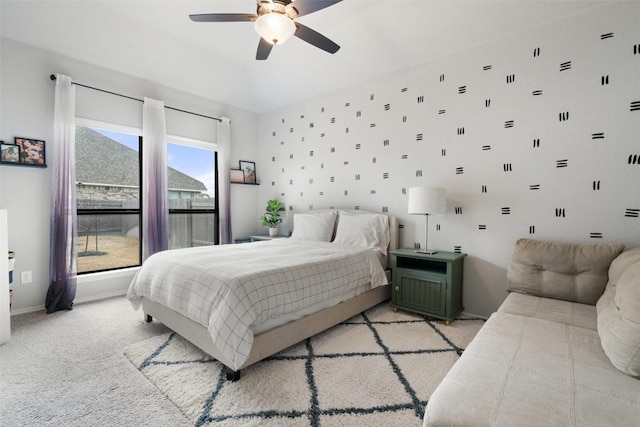 bedroom featuring light carpet, a ceiling fan, and baseboards