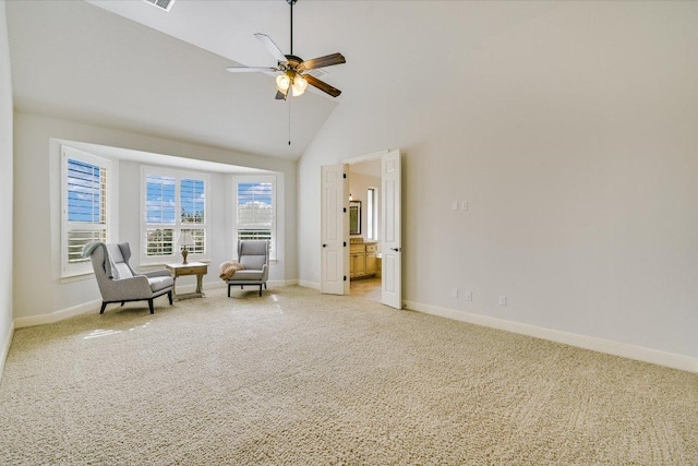 living area with high vaulted ceiling, light colored carpet, ceiling fan, and baseboards