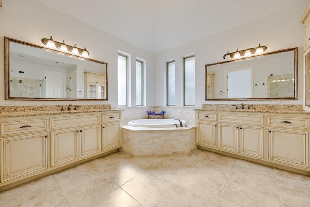 bathroom featuring a bath, a sink, and tiled shower