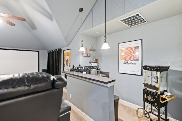 home theater with lofted ceiling, carpet flooring, visible vents, baseboards, and indoor wet bar