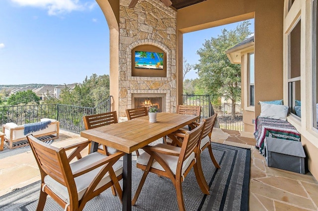 view of patio / terrace with an outdoor stone fireplace and outdoor dining space