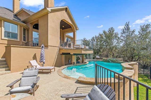 view of pool with a patio and a pool with connected hot tub