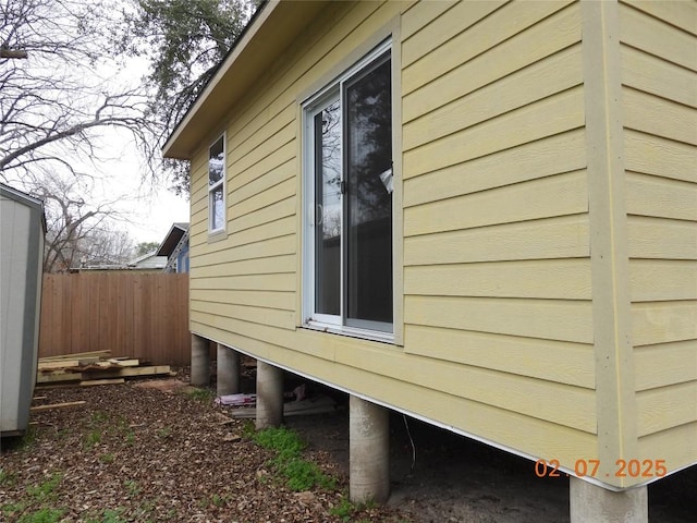 view of side of property featuring fence