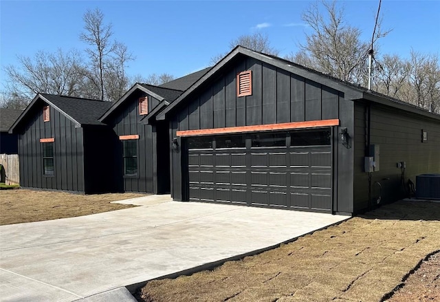 modern farmhouse style home with board and batten siding, driveway, an attached garage, and central AC unit