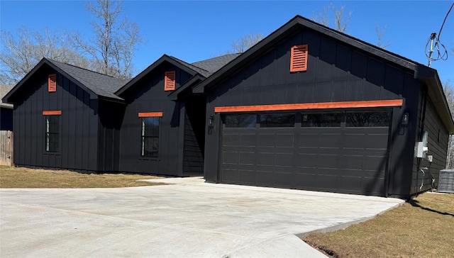 view of front of home with concrete driveway, an attached garage, and board and batten siding