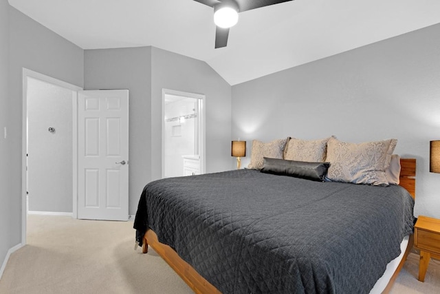 bedroom featuring light colored carpet, ensuite bathroom, vaulted ceiling, ceiling fan, and baseboards