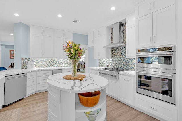 kitchen with visible vents, stainless steel appliances, wall chimney range hood, white cabinetry, and open shelves