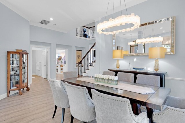 dining space featuring recessed lighting, visible vents, wood finished floors, baseboards, and stairs