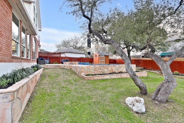 view of yard with a fenced backyard, an outdoor structure, and a storage shed