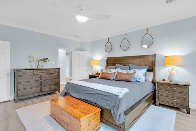 bedroom with ornamental molding, wood finished floors, a ceiling fan, and baseboards