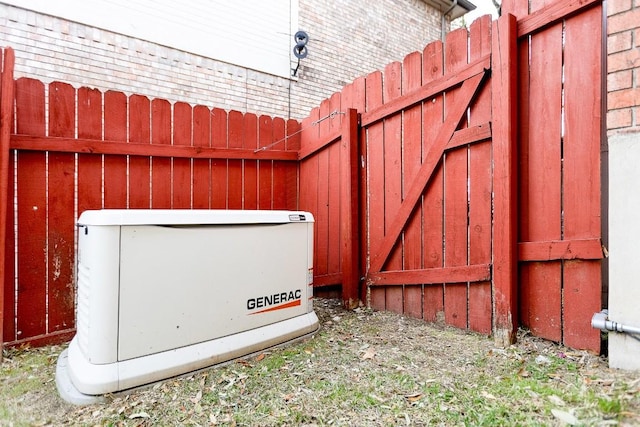 details featuring fence and a power unit