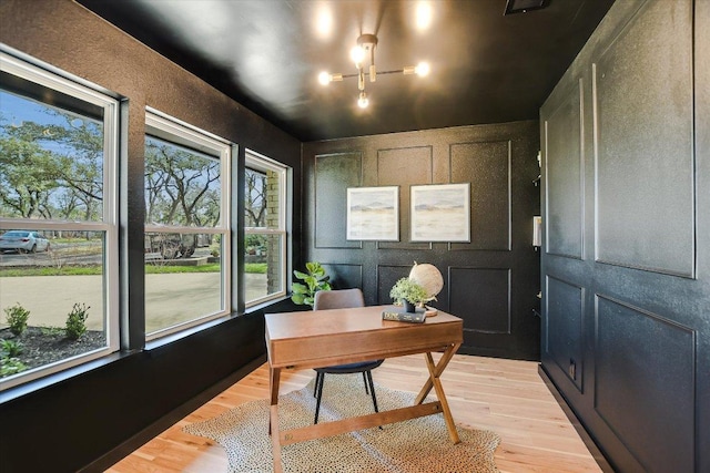 office space with a decorative wall and light wood finished floors