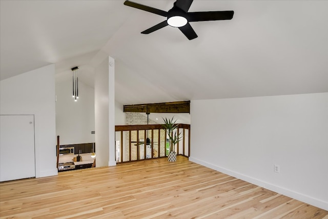 additional living space featuring a ceiling fan, lofted ceiling, baseboards, and wood finished floors