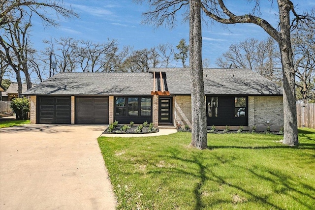 mid-century inspired home featuring an attached garage, brick siding, a shingled roof, driveway, and a front lawn