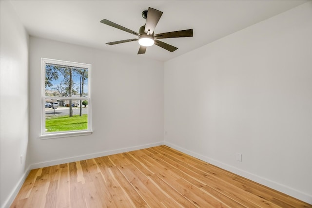 empty room featuring baseboards, ceiling fan, and light wood finished floors